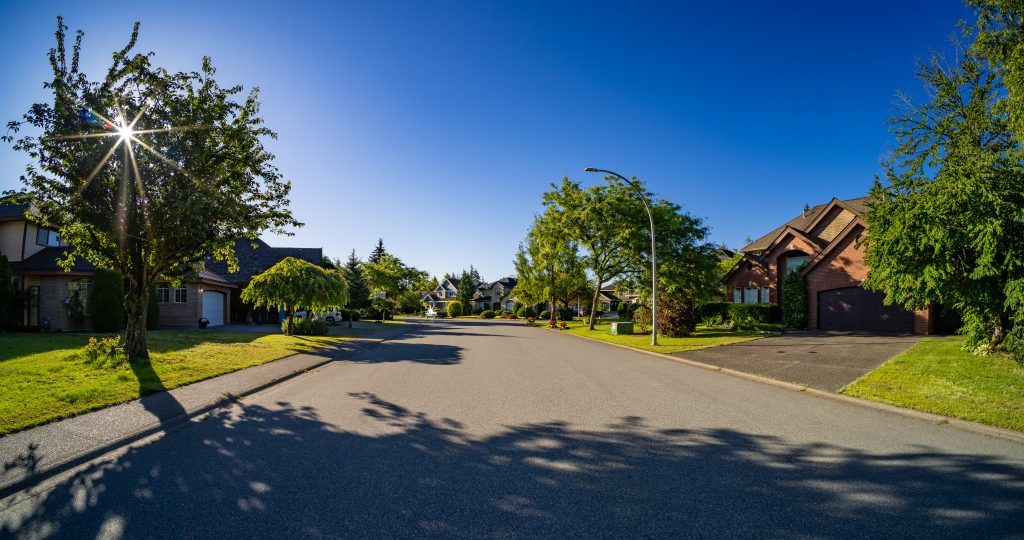 Cohesive HOA streetscape in a central Indiana residential community with uniform mailboxes and signage